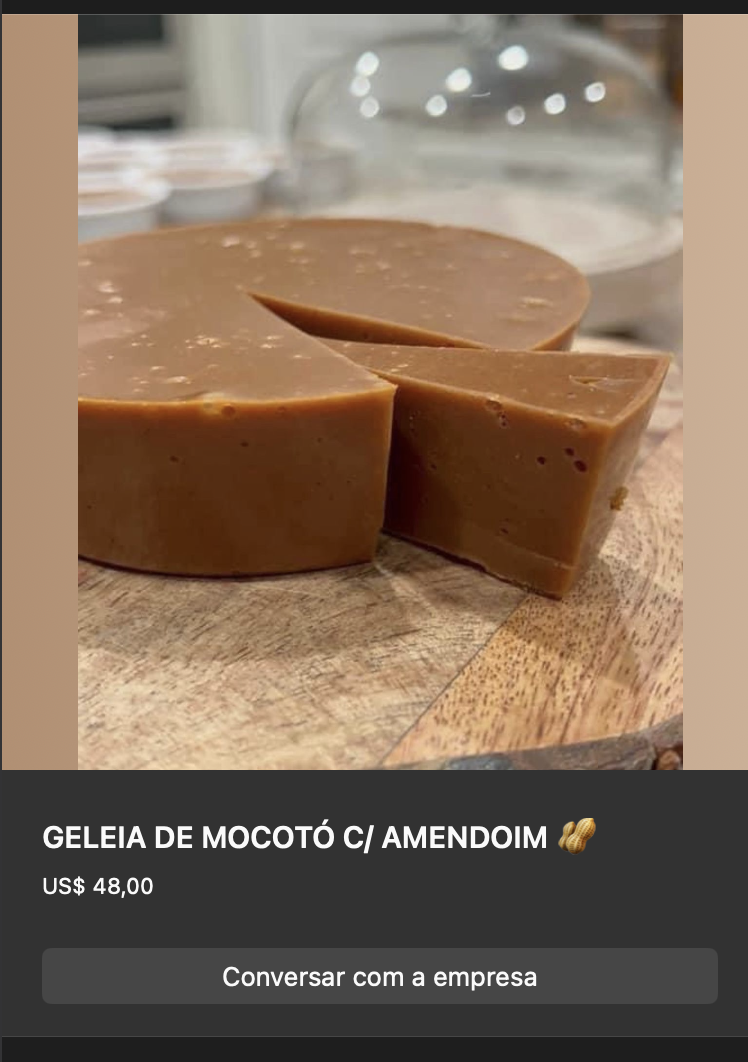 Bloco de geleia de mocotó com amendoim, cor caramelo escura, formato circular cortado em pedaços sobre tábua de madeira. Textura firme.